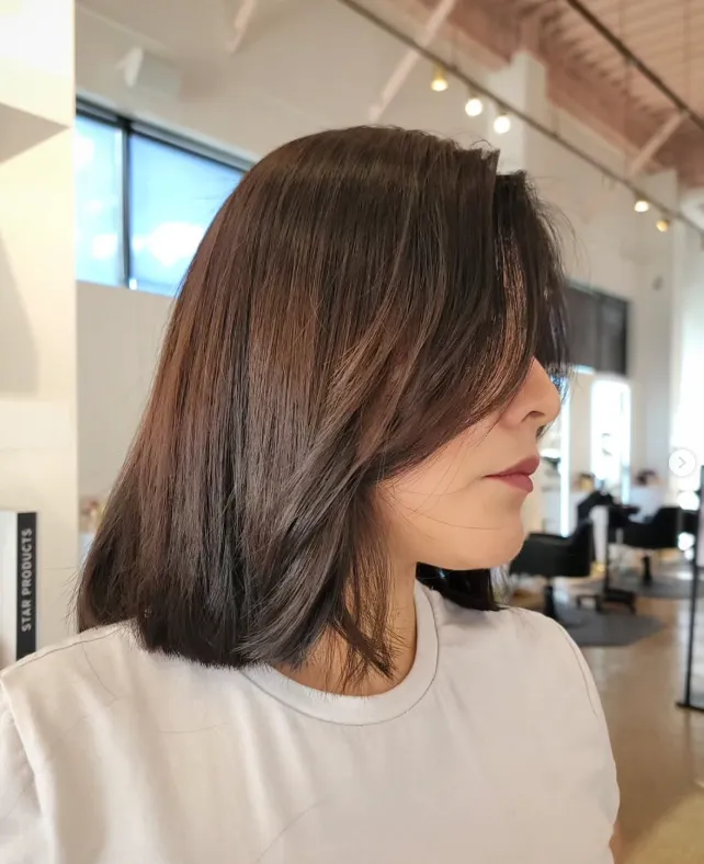 Shoulder-length brunette haircut with soft face-framing layers