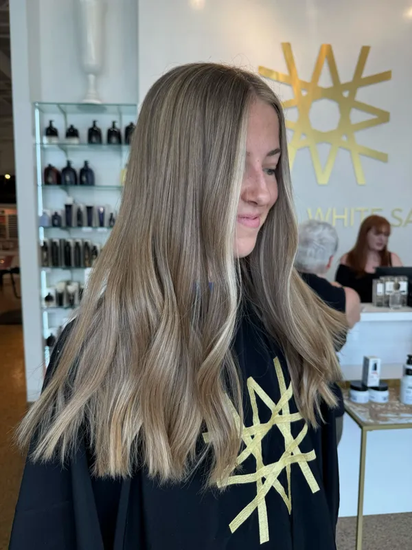 Long sandy blonde hair with soft dimensional highlights by Christina White Salon